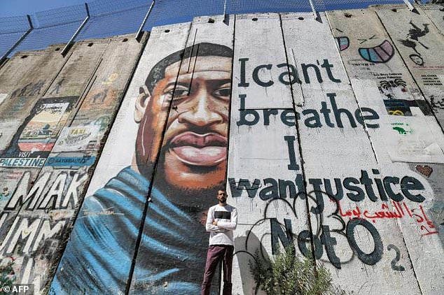 Palestinian artist paints murals on Israeli occupation  barrier